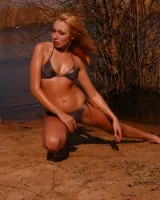 Blonde beauty is by the lake in sexty bikini