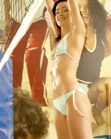 Indoor beach volleyball player in sexy bikini undresses to show perfect slim nude body with puffy nipples