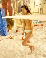 Indoor beach volleyball player in sexy bikini undresses to show perfect slim nude body with puffy nipples