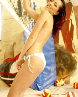 Indoor beach volleyball player in sexy bikini undresses to show perfect slim nude body with puffy nipples