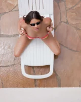 Latin baby resting in sexy bikini and black sunglasses
