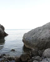 Hairy pussy brunette with puffy nipples wears red dotted bikini and strips to show her remarkable nude body at the rocks