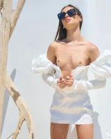 Passionate brunette in white micro bikini has puffy nipples