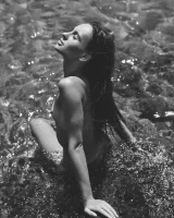 Nude beach brunette with puffy nipples in red micro bikini