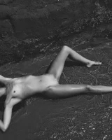 Nude beach brunette with puffy nipples in red micro bikini