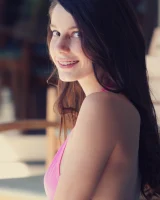 Young sexy brunette in pink bikini has perfect body with puffy nipples