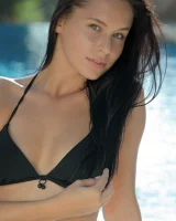 Exciting flexible beauty is by the pool in black bikini