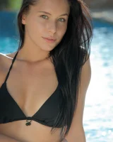 Exciting flexible beauty is by the pool in black bikini