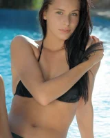 Exciting flexible beauty is by the pool in black bikini